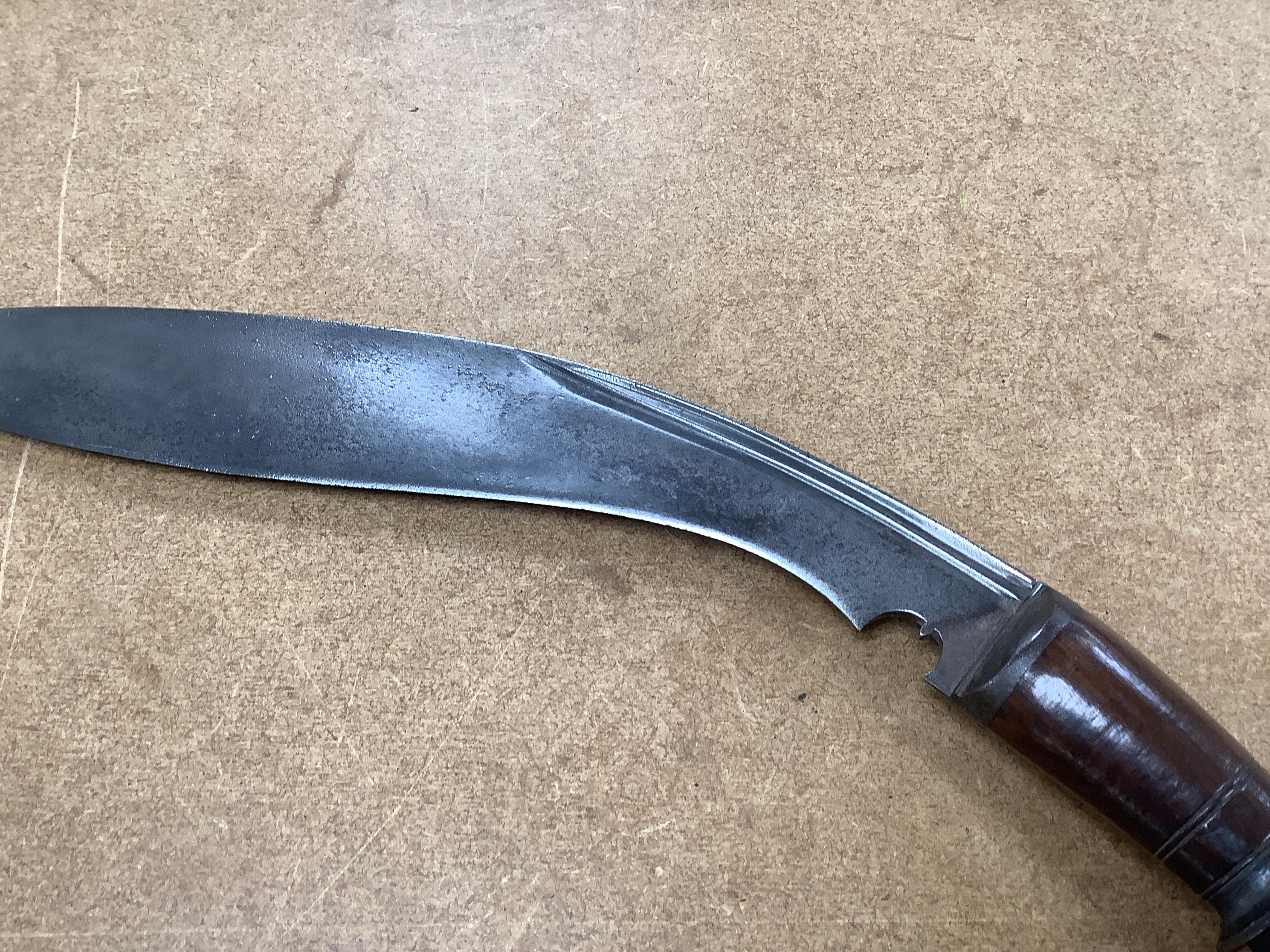 Four bladed weapons; an Indian sword Tulwar, blade 68.5cm. Condition - poor, heavily pitted., A Nepalese Kukri. Condition - fair., A Thai sword Dha, with a lacquered hilt and wooden scabbard, blade 56cm. Condition - fair